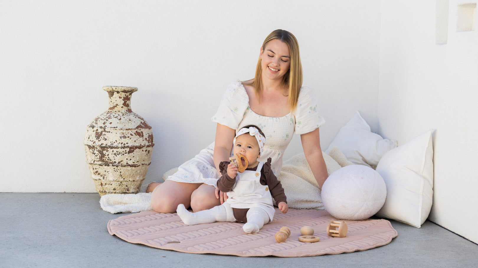 Pampas play mat with mother, newborn and toddler playing on the mat