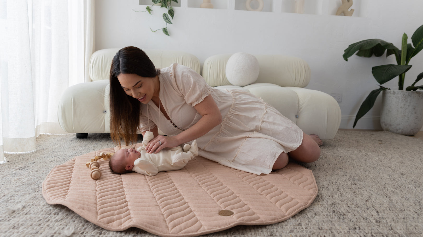 mother bonding with newborn on The Kairos Child Pampas play mat during tummy time