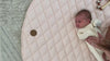 The Kairos Child's Positano Linen Play Mat with mother interacting with newborn baby